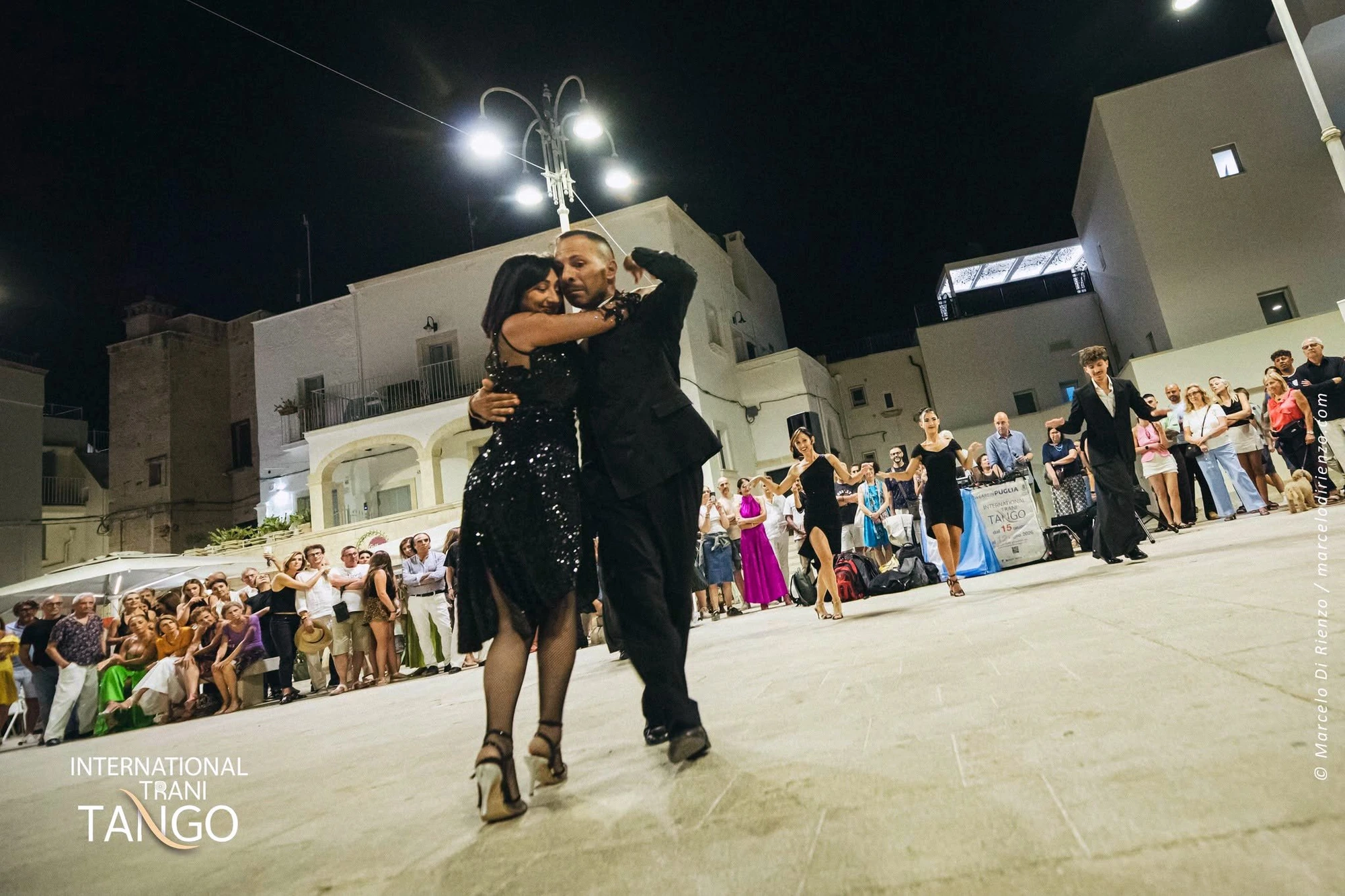 Coppia di tango nell'abbraccio durante un'esibizione serale